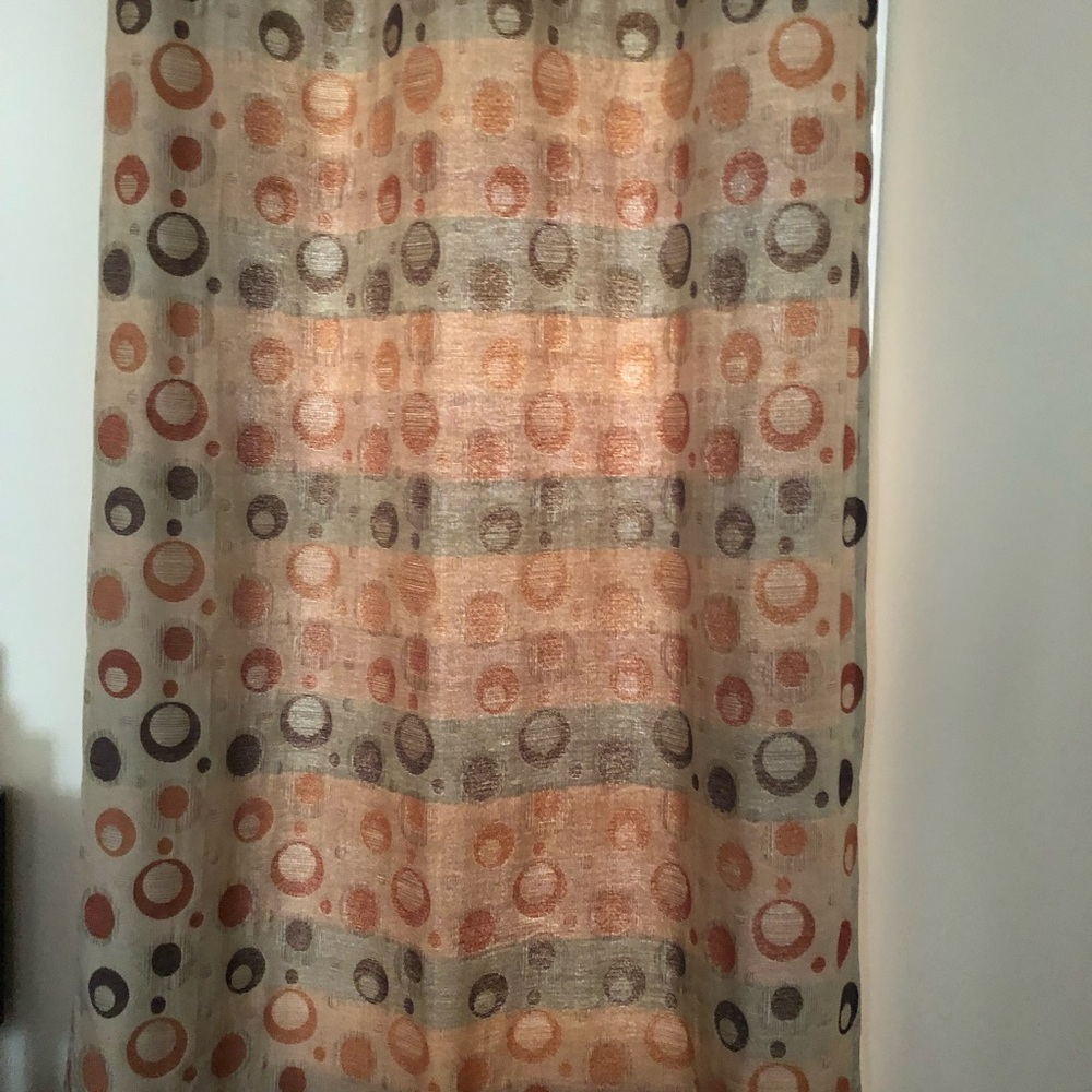 2- 50”w x 84” L curtain panels.  
Geometric Patterned in Orange and Brown.